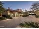 Attached garage with decorative doors and landscaping at 10493 E Rimrock Dr, Scottsdale, AZ 85255