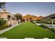 Expansive backyard with a putting green, pool, and mountain views at 10493 E Rimrock Dr, Scottsdale, AZ 85255