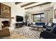 Living room features a fireplace, large sectional sofa and mountain views at 10493 E Rimrock Dr, Scottsdale, AZ 85255