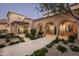 Charming courtyard entry with arched walkways and lush landscaping at 10493 E Rimrock Dr, Scottsdale, AZ 85255