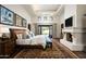 Main bedroom features a comfortable bed, fireplace, and access to a patio at 10493 E Rimrock Dr, Scottsdale, AZ 85255