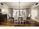 Elegant dining room with a large table, hardwood floors and access to a courtyard at 10493 E Rimrock Dr, Scottsdale, AZ 85255