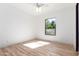 Well-lit bedroom featuring hardwood floors and a large window at 7113 N 183Rd Ave, Waddell, AZ 85355