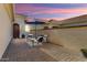 Patio with seating area and umbrella at sunset at 12941 W El Sueno Ct, Sun City West, AZ 85375