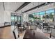 Dining area with large windows and modern tables and chairs at 12941 W El Sueno Ct, Sun City West, AZ 85375