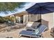 Patio with lounge chairs and umbrella for outdoor relaxation at 12941 W El Sueno Ct, Sun City West, AZ 85375