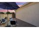 Patio with seating area and umbrella at sunset at 12941 W El Sueno Ct, Sun City West, AZ 85375