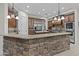 Kitchen with large island and stonework breakfast bar at 3520 E Pearl Cir, Mesa, AZ 85213