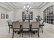 Formal dining room with large table, chandelier, and built-in hutch at 3520 E Pearl Cir, Mesa, AZ 85213