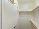 Spacious closet with wood shelving and hanging rods at 2402 E 5Th St # 1429, Tempe, AZ 85288