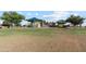 Community playground with play structures and grassy area at 38125 W Excussare Way, Maricopa, AZ 85138