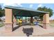 Community ramada with picnic tables and grill at 38125 W Excussare Way, Maricopa, AZ 85138