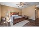 Bedroom with wood flooring, ceiling fan, and a large bed at 11110 N 165Th Ave, Surprise, AZ 85388