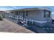 Gray mobile home with covered porch and ramp access at 2460 E Main St # A17, Mesa, AZ 85213