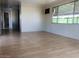 Bright living room with light wood laminate flooring at 2460 E Main St # A17, Mesa, AZ 85213
