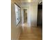 Long hallway with light walls and laminate flooring at 2460 E Main St # A17, Mesa, AZ 85213