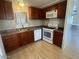 Galley kitchen with wood cabinets and modern appliances at 2460 E Main St # A17, Mesa, AZ 85213