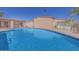 Community pool with surrounding patio furniture at 2460 E Main St # A17, Mesa, AZ 85213