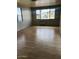 Spacious living room featuring large windows and laminate flooring at 2460 E Main St # A17, Mesa, AZ 85213