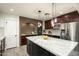 Modern kitchen with granite countertops, stainless steel appliances, and dark wood cabinets at 39839 N Spur Cross Rd, Cave Creek, AZ 85331