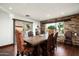 Rustic dining room with stone wall, wooden table, and leather chairs at 39839 N Spur Cross Rd, Cave Creek, AZ 85331