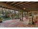 Covered patio with brick pavers, outdoor bar, and scenic backyard views at 39839 N Spur Cross Rd, Cave Creek, AZ 85331