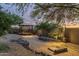 Landscaped backyard with a horseshoe pit and pergola at 39839 N Spur Cross Rd, Cave Creek, AZ 85331