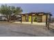 Covered barn with stalls and a large parking area at 39839 N Spur Cross Rd, Cave Creek, AZ 85331