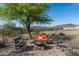 Relaxing fire pit area with rocking chairs and a view of the surrounding landscape at 39839 N Spur Cross Rd, Cave Creek, AZ 85331