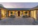Elegant courtyard entry with brick pavers, potted plants, and a wooden door at 39839 N Spur Cross Rd, Cave Creek, AZ 85331