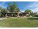Large backyard with grassy lawn, brick patio, and a view of the house at 39839 N Spur Cross Rd, Cave Creek, AZ 85331