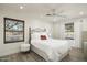 Bright bedroom with wood floors and white bedding at 39839 N Spur Cross Rd, Cave Creek, AZ 85331