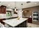 Modern kitchen with granite countertops, stainless steel appliances, and dark wood cabinets at 39839 N Spur Cross Rd, Cave Creek, AZ 85331