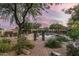 Inviting pool area with brick pathway, lush landscaping, and mountain views at 39839 N Spur Cross Rd, Cave Creek, AZ 85331