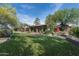 Landscaped backyard showcasing a large green lawn and the home's exterior at 39839 N Spur Cross Rd, Cave Creek, AZ 85331