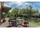 Patio with a bistro set, string lights, and a view of the beautifully landscaped backyard at 39839 N Spur Cross Rd, Cave Creek, AZ 85331
