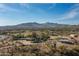 Aerial view of property showing house, pool, stables, and mountain views at 39839 N Spur Cross Rd, Cave Creek, AZ 85331
