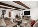 Living room with rustic decor, hardwood floors, and leather sofas at 39839 N Spur Cross Rd, Cave Creek, AZ 85331