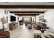 Spacious living room with hardwood floors, leather sofas, and a large TV at 39839 N Spur Cross Rd, Cave Creek, AZ 85331