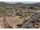 Aerial view of property showing house, pool, and surrounding desert landscape at 39839 N Spur Cross Rd, Cave Creek, AZ 85331