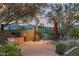 Evening view of a brick patio with outdoor seating, grill, and string lights at 39839 N Spur Cross Rd, Cave Creek, AZ 85331