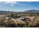 Aerial view of property showing a large lot with a barn and mountains in the background at 39839 N Spur Cross Rd, Cave Creek, AZ 85331