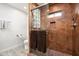 Shower with glass enclosure, stone accents and tiled walls at 39839 N Spur Cross Rd, Cave Creek, AZ 85331
