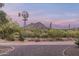 Windmill and mountain view from a brick paved pathway at 39839 N Spur Cross Rd, Cave Creek, AZ 85331