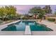 Stunning pool with diving board and a view of the house and mountains at 39839 N Spur Cross Rd, Cave Creek, AZ 85331