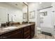 Bathroom with granite countertop, dark wood cabinets, and bathtub at 39839 N Spur Cross Rd, Cave Creek, AZ 85331