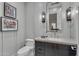 Stylish bathroom with dark vanity and a large mirror at 20445 E Sunset Ct, Queen Creek, AZ 85142