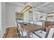 Elegant dining room with a long wooden table, chandelier, and hardwood floors at 20445 E Sunset Ct, Queen Creek, AZ 85142