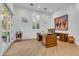 Bright office with large windows, custom desk, and hardwood floors at 20445 E Sunset Ct, Queen Creek, AZ 85142