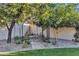 Landscaped backyard with a stone path, arbor, and seating area at 20445 E Sunset Ct, Queen Creek, AZ 85142